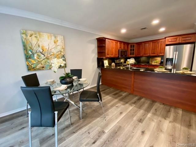 24 Neal Path, Unit 24 Centereach, NY 11720 - Photo 3 of 10 a view of a dining room with furniture window and wooden floor