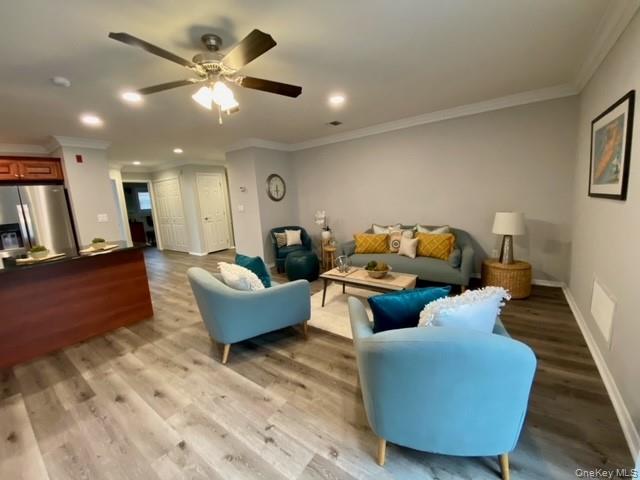24 Neal Path, Unit 24 Centereach, NY 11720 - Photo 5 of 10 a living room with furniture and a chandelier