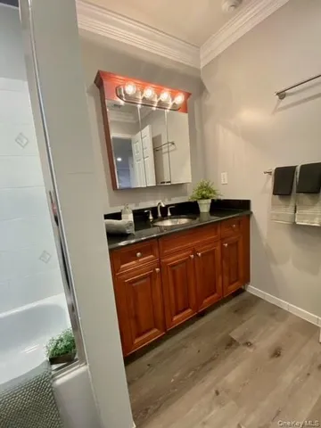 a bathroom with a sink a mirror and a bathtub