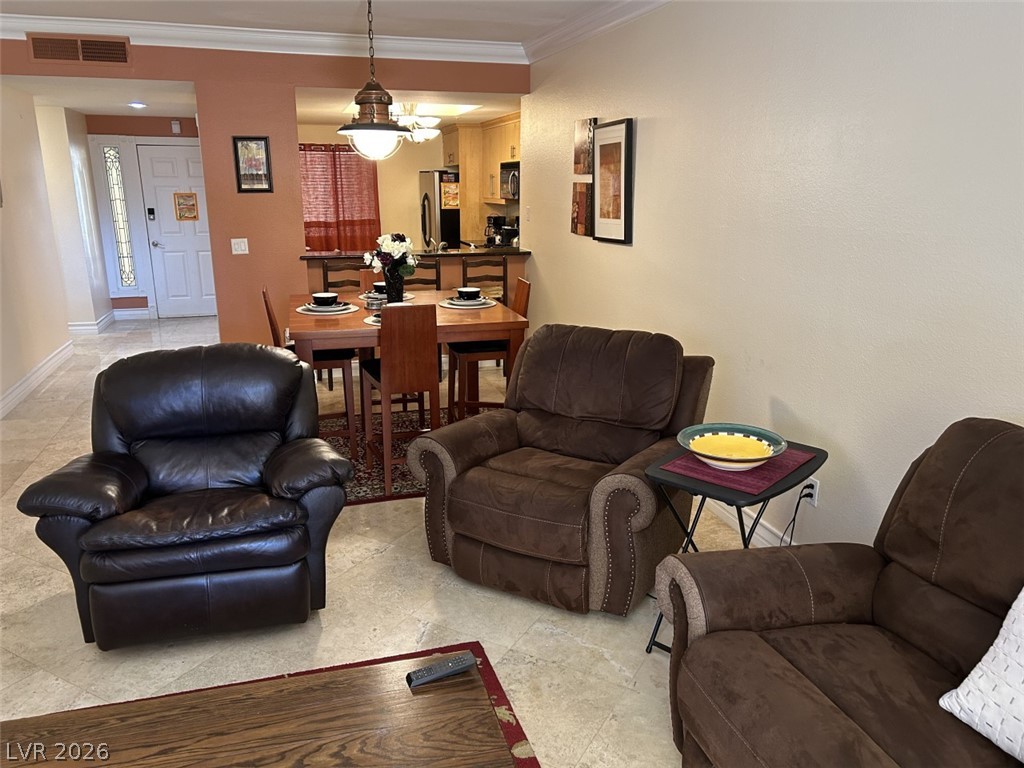 210 East Flamingo Road, Unit 137 Las Vegas, NV 89169 - Photo 3 of 32 An inviting open-concept layout connects the living area to a dining space and kitchen, perfect for entertaining.