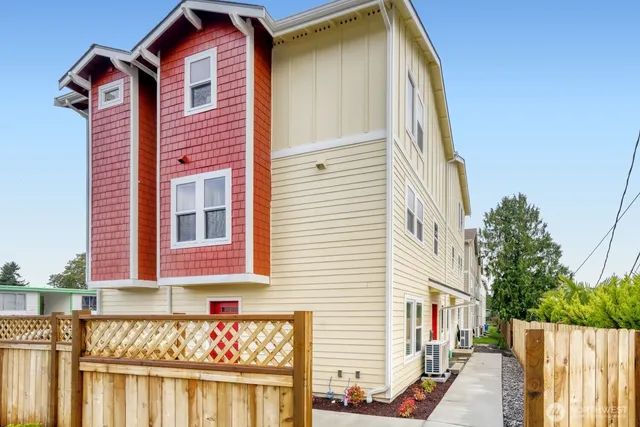 a view of a house with a wooden fence