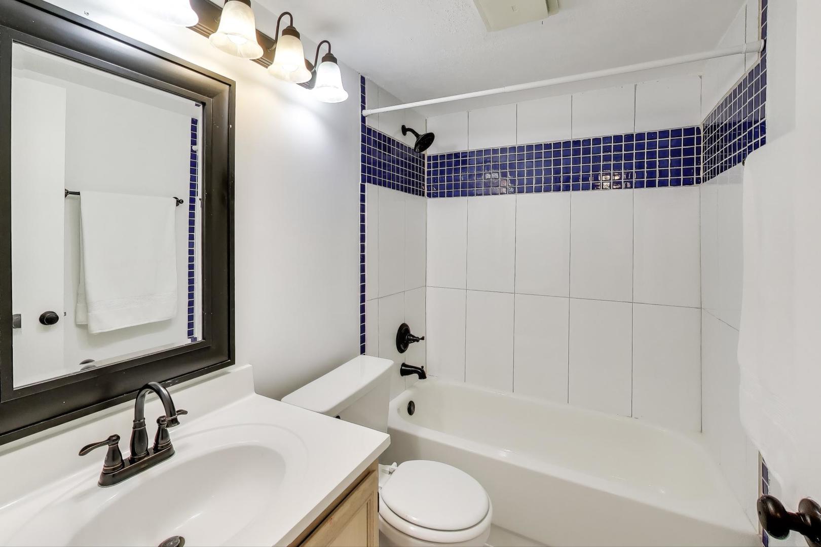 1011 Wesley Lane Algonquin, IL 60102 - Photo 12 of 24 a bathroom with a sink toilet a shower and a mirror