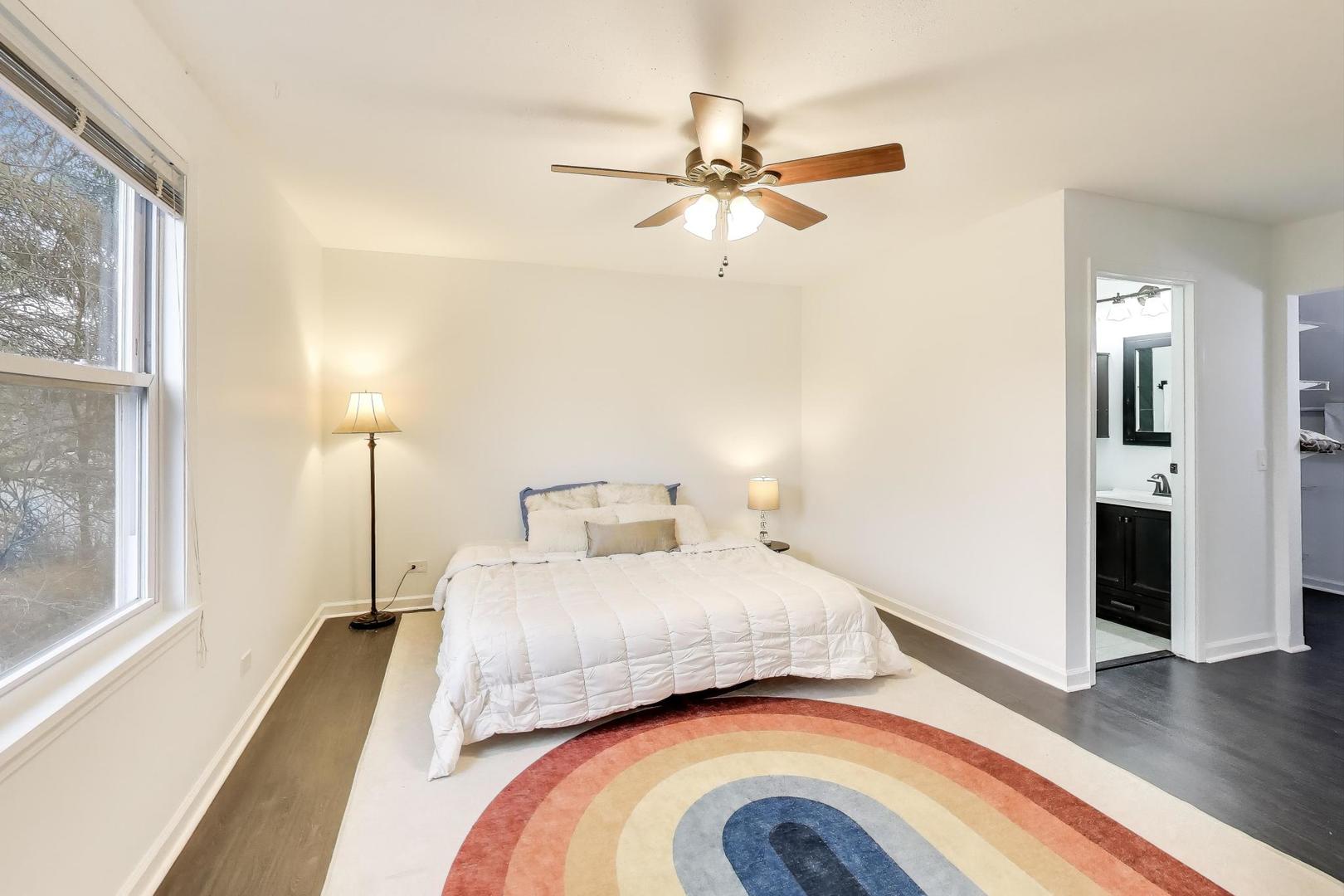 1011 Wesley Lane Algonquin, IL 60102 - Photo 13 of 24 a bedroom with a bed and a chandelier