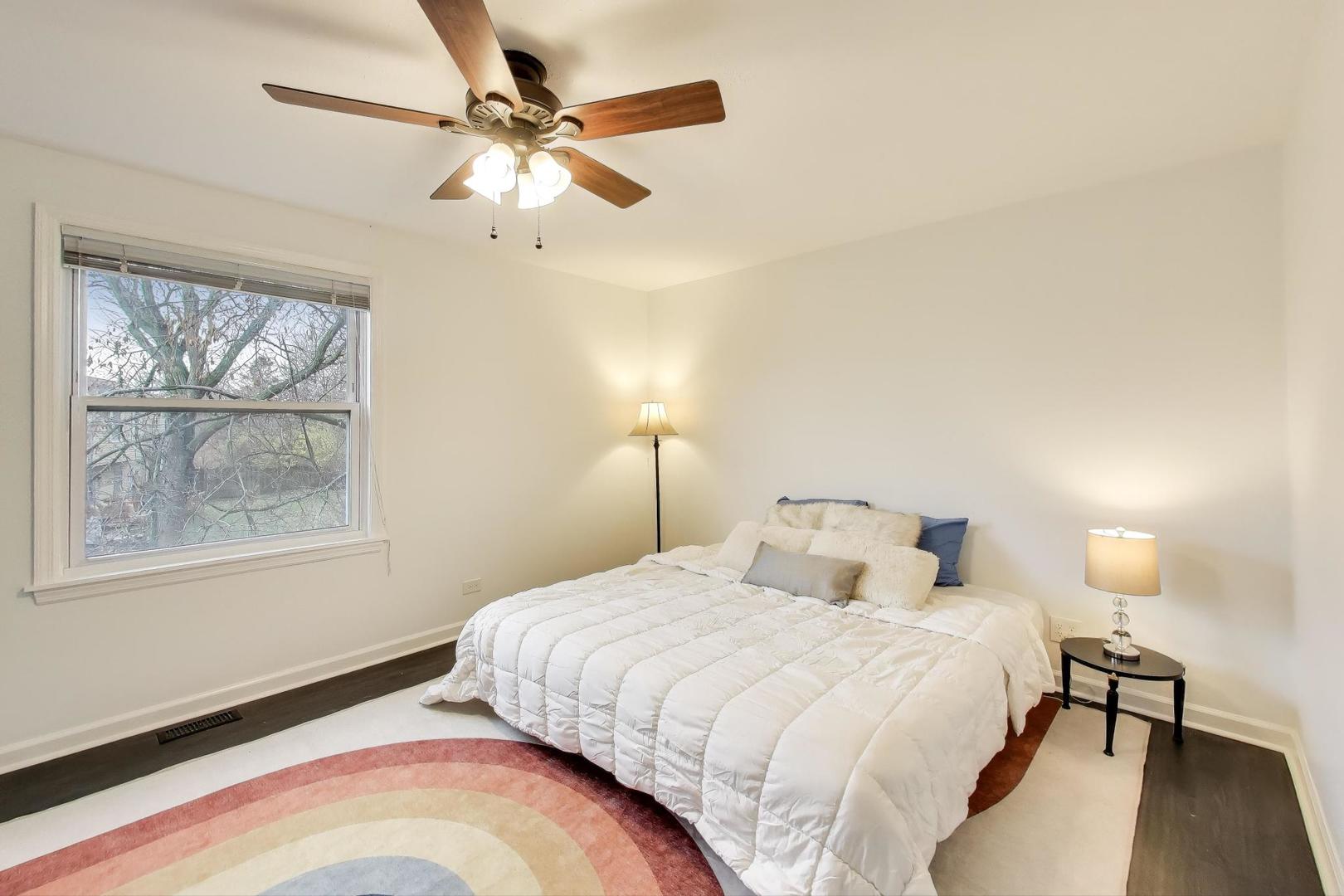 1011 Wesley Lane Algonquin, IL 60102 - Photo 14 of 24 a bedroom with a bed and a chandelier