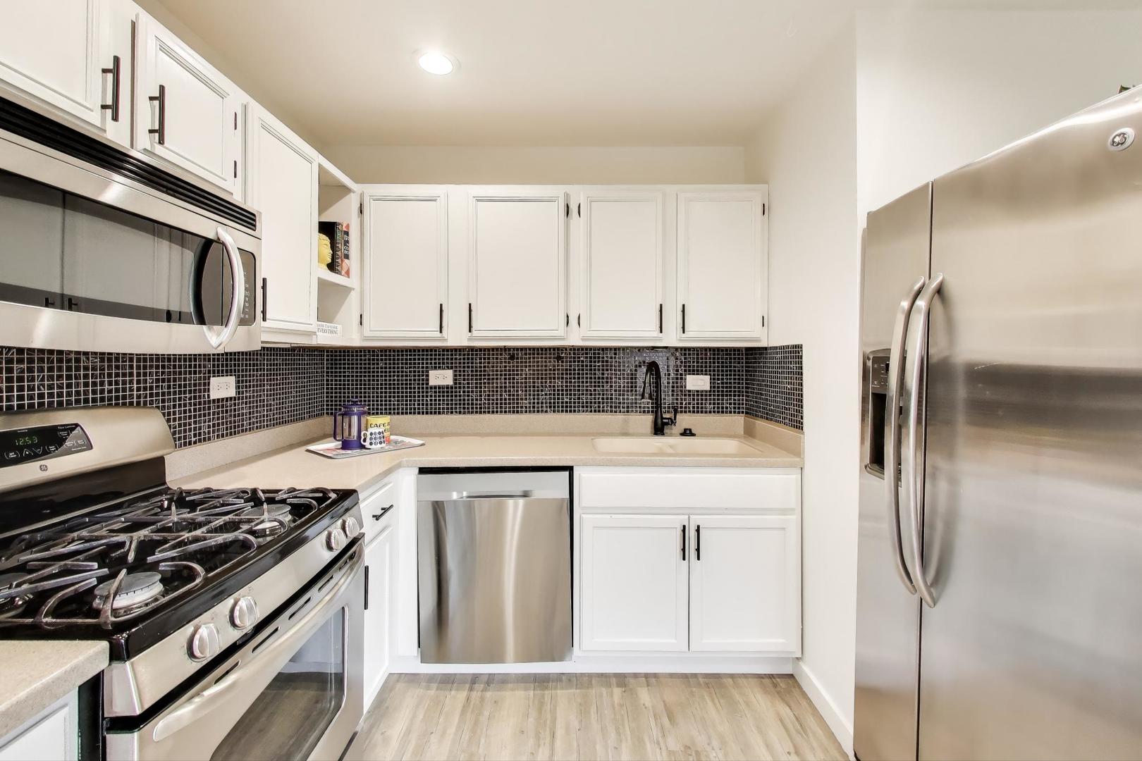 1011 Wesley Lane Algonquin, IL 60102 - Photo 9 of 24 a kitchen with stainless steel appliances granite countertop a stove a refrigerator and a cabinets