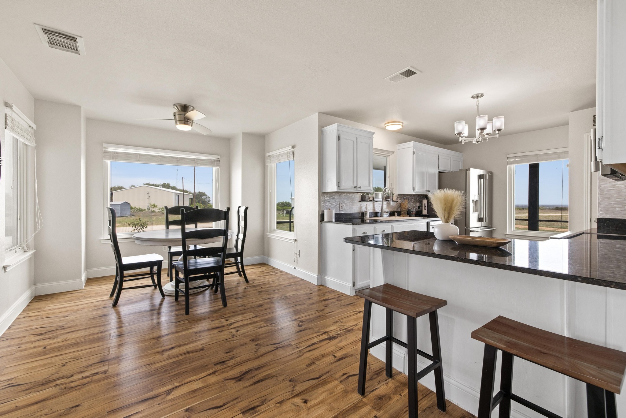 1283 Rattlesnake Trail Burnet, TX 78611 - Photo 12 of 40 a kitchen with stainless steel appliances a dining table chairs stove and cabinets