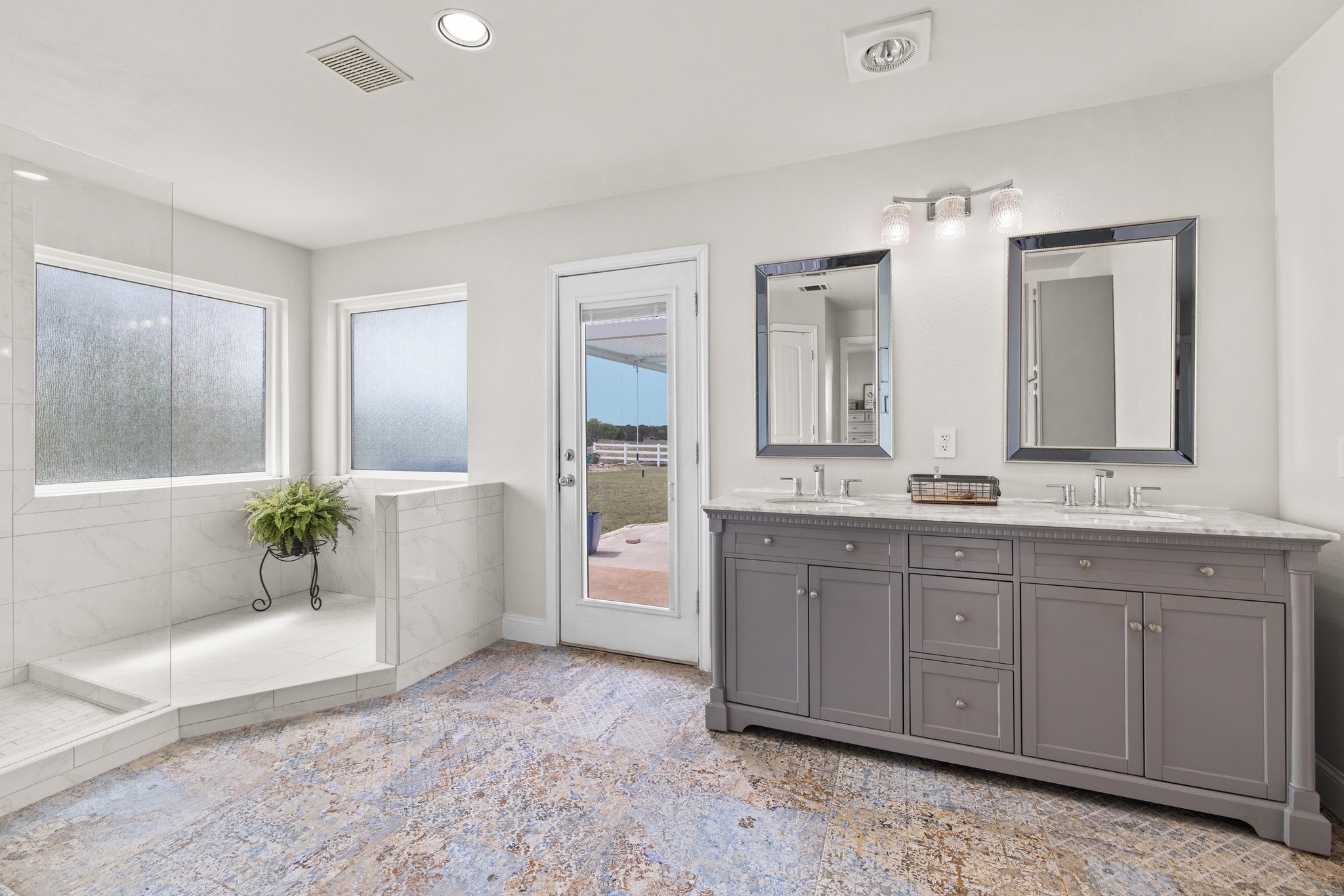 1283 Rattlesnake Trail Burnet, TX 78611 - Photo 14 of 40 a spacious bathroom with a double vanity sink a mirror a bathtub and next to a window