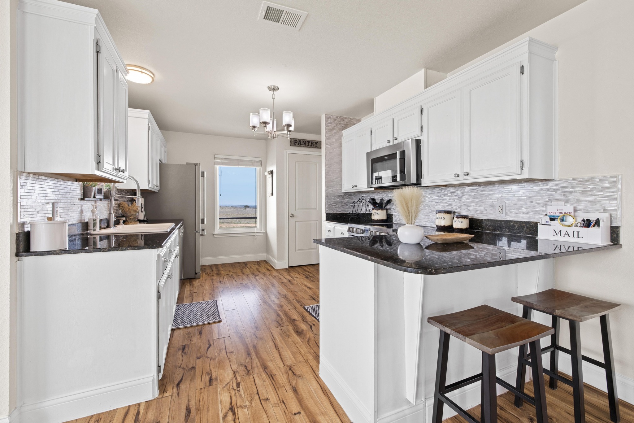 1283 Rattlesnake Trail Burnet, TX 78611 - Photo 10 of 40 a kitchen with stainless steel appliances a stove a sink a refrigerator and cabinets
