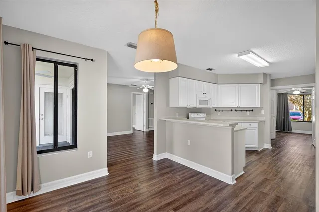 a kitchen with sink cabinets and wooden floor