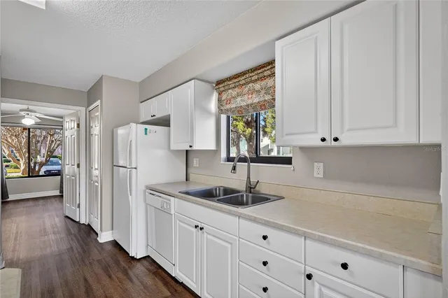 a kitchen with appliances cabinets and a counter top space
