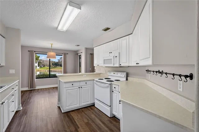 a kitchen with a sink a stove and cabinets