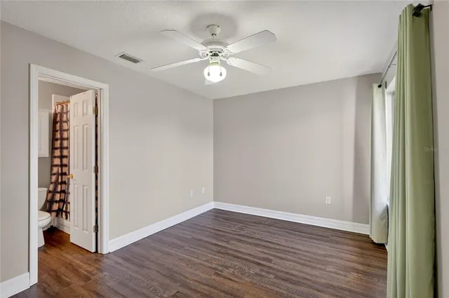 wooden floor in an empty room with a mirror
