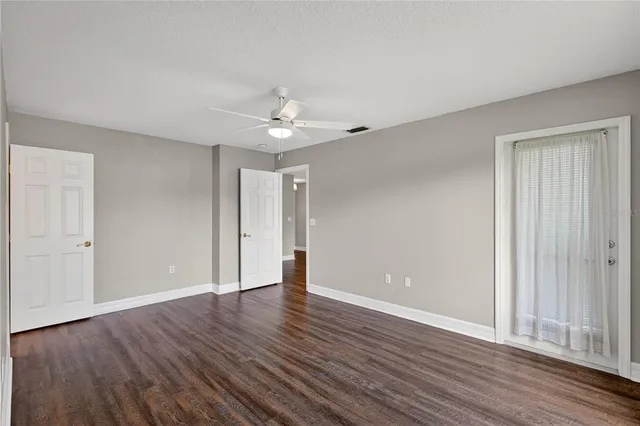 a view of an empty room with wooden floor