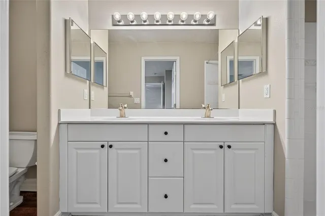 a bathroom with a double vanity sink and a mirror
