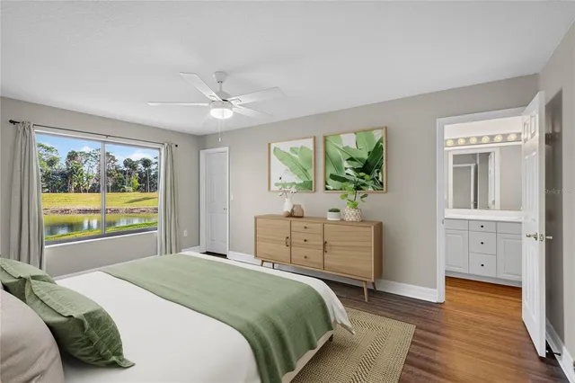 a bedroom with a bed potted plant with the large window