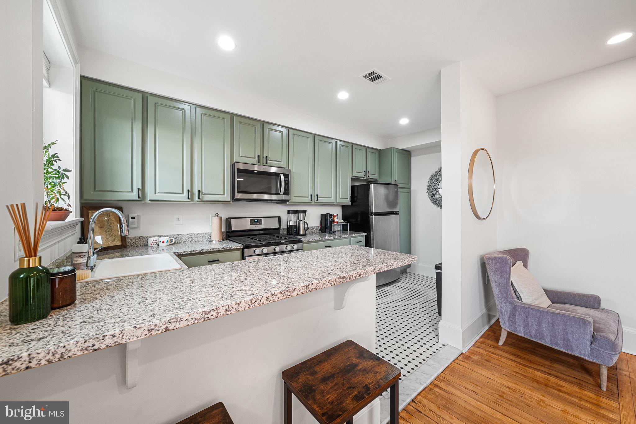 1423 R Street Northwest, Unit 402 Washington, DC 20009 - Photo 13 of 37 Updated Kitchen with Eat-In Island