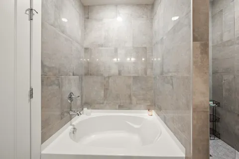 a bedroom with a bed lamp and a potted plant
