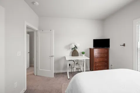 a bedroom with a bed and a tv on table