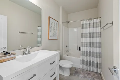 a bedroom with a bed and a flat tv screen on a dresser