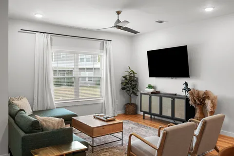 a dining room with furniture and a kitchen view