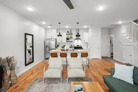 a kitchen that has a lot of cabinets a sink and appliances in it