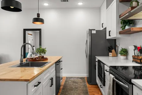 a living room with furniture and a potted plant