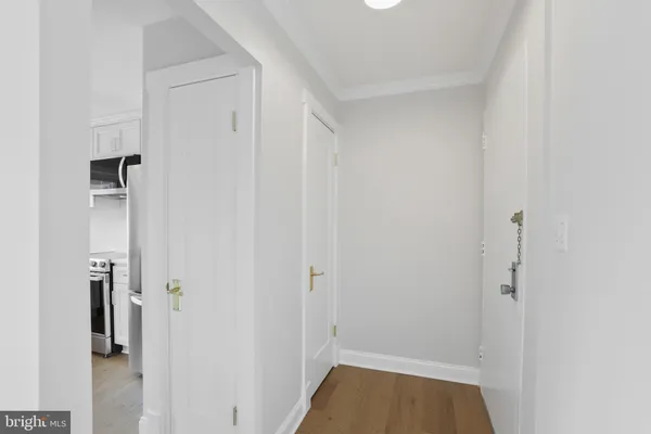 a view of a hallway with closet and a bathroom