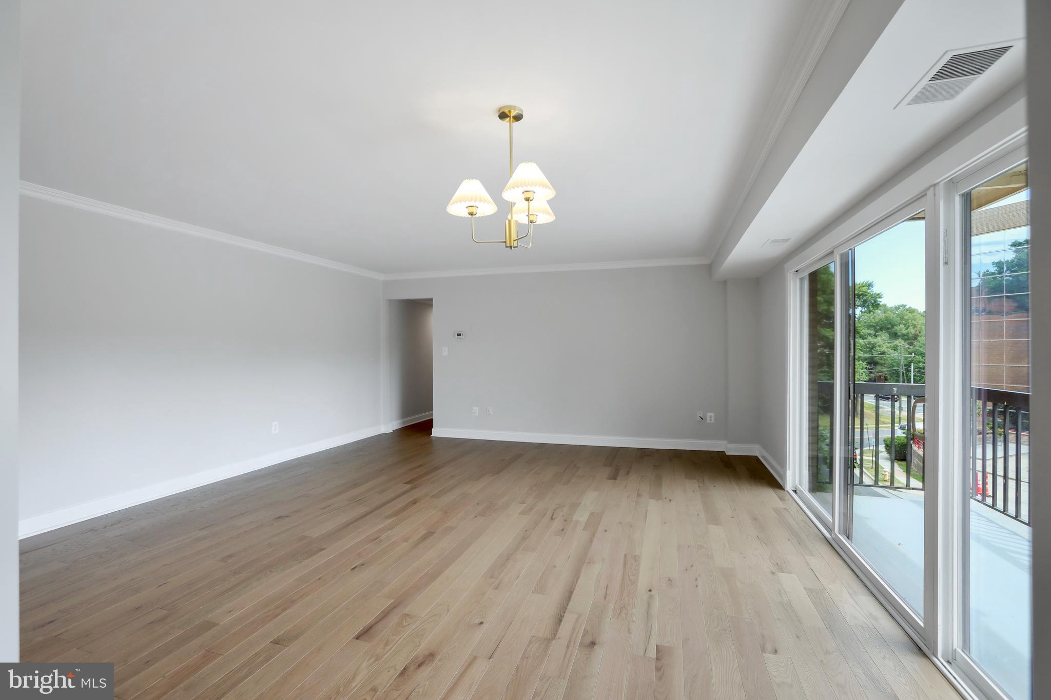 3200 South 28th Street, Unit 302 Alexandria, VA 22302 - Photo 9 of 14 wooden floor in an empty room with a window