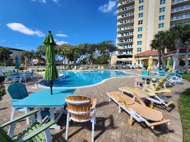 2801 South Ridgewood Avenue, Unit 403 South Daytona, FL 32119 - Photo 14 of 16 a view of a patio with chairs and table