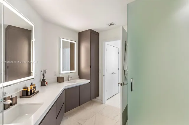 a spacious bathroom with a double vanity sink mirror and double
