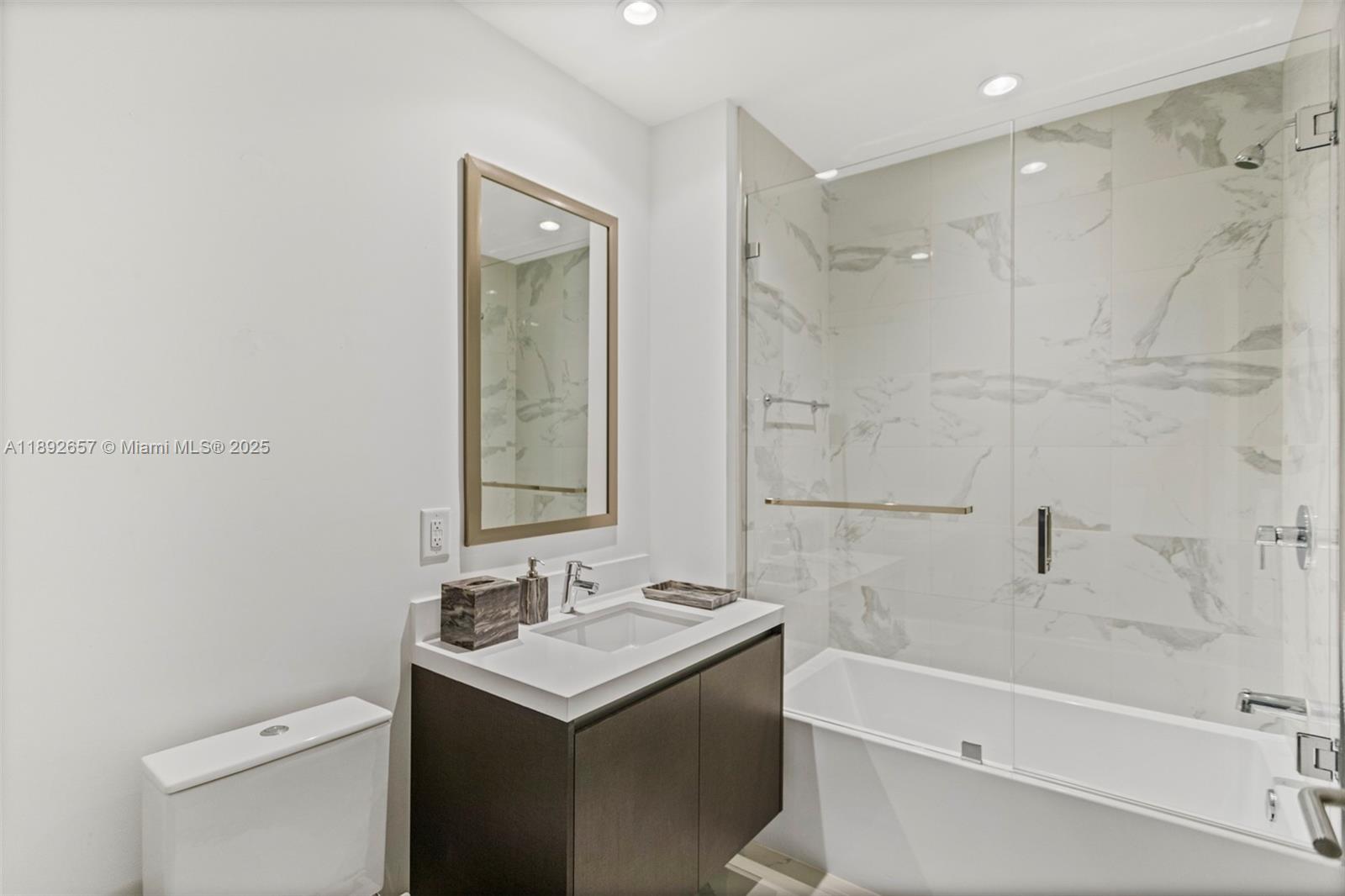 851 Northeast 1st Avenue, Unit 3707 Miami, FL 33132 - Photo 23 of 28 a bathroom with a sink and a mirror