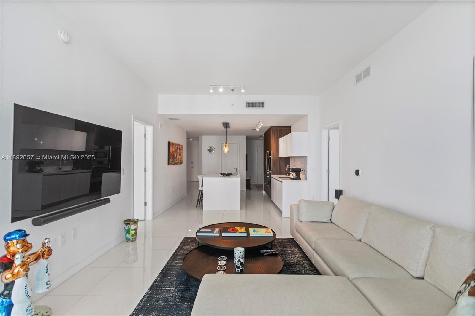 851 Northeast 1st Avenue, Unit 3707 Miami, FL 33132 - Photo 7 of 28 a living room with furniture and a flat screen tv