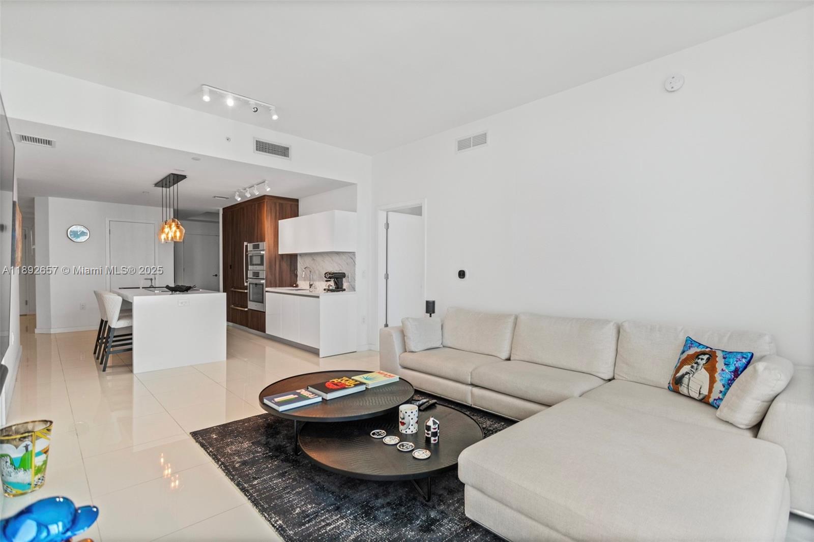 851 Northeast 1st Avenue, Unit 3707 Miami, FL 33132 - Photo 8 of 28 a living room with furniture and a table