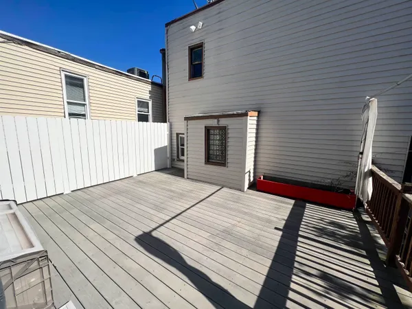 a terrace with wooden floor and chair