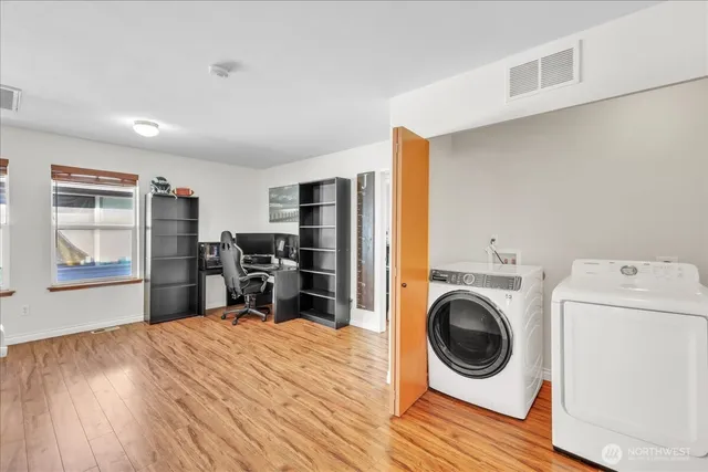 a view of a bedroom with washer and dryer