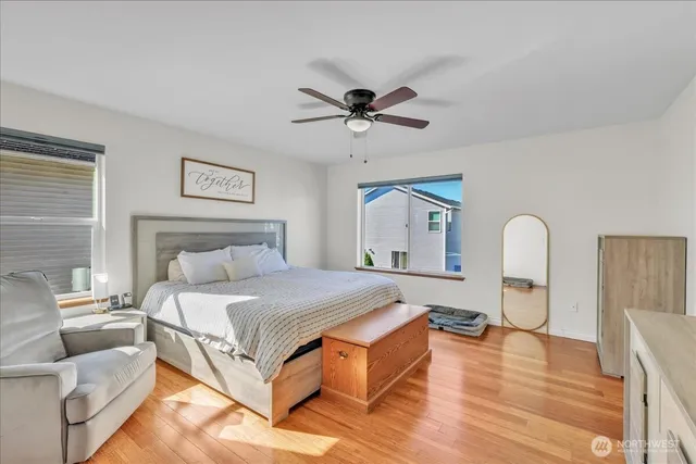 a bedroom with a bed couch and window