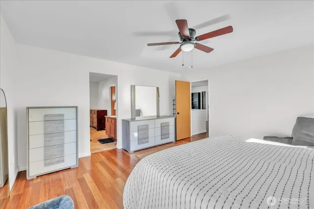 a bedroom with a large bed and a chandelier