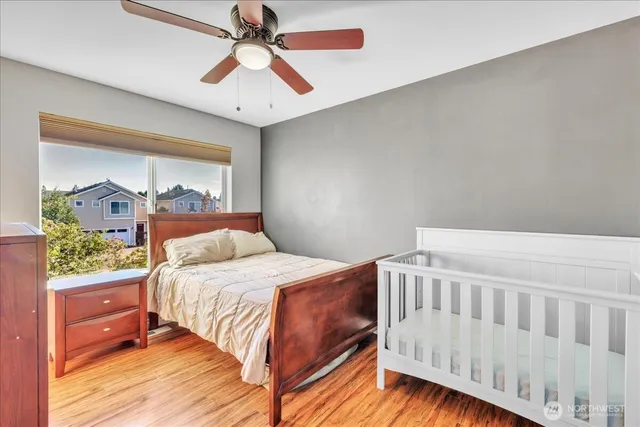 a bedroom with a bed and wooden floor