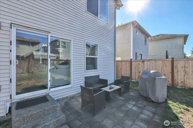 a view of a house with backyard and sitting area