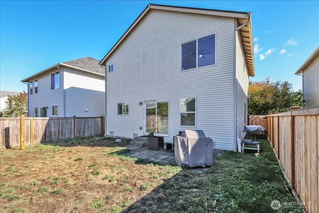 a view of backyard with wooden fence