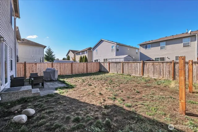 a view of backyard of house and trees