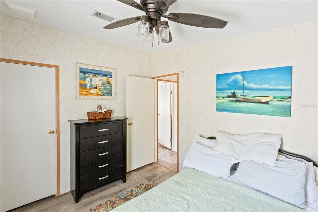 5670 Acadia Street Keystone Heights, FL 32656 - Photo 54 of 65 a bedroom with a bed and a dresser