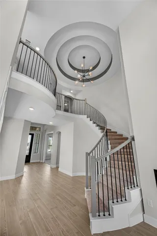 a view of an entryway wooden floor and staircase