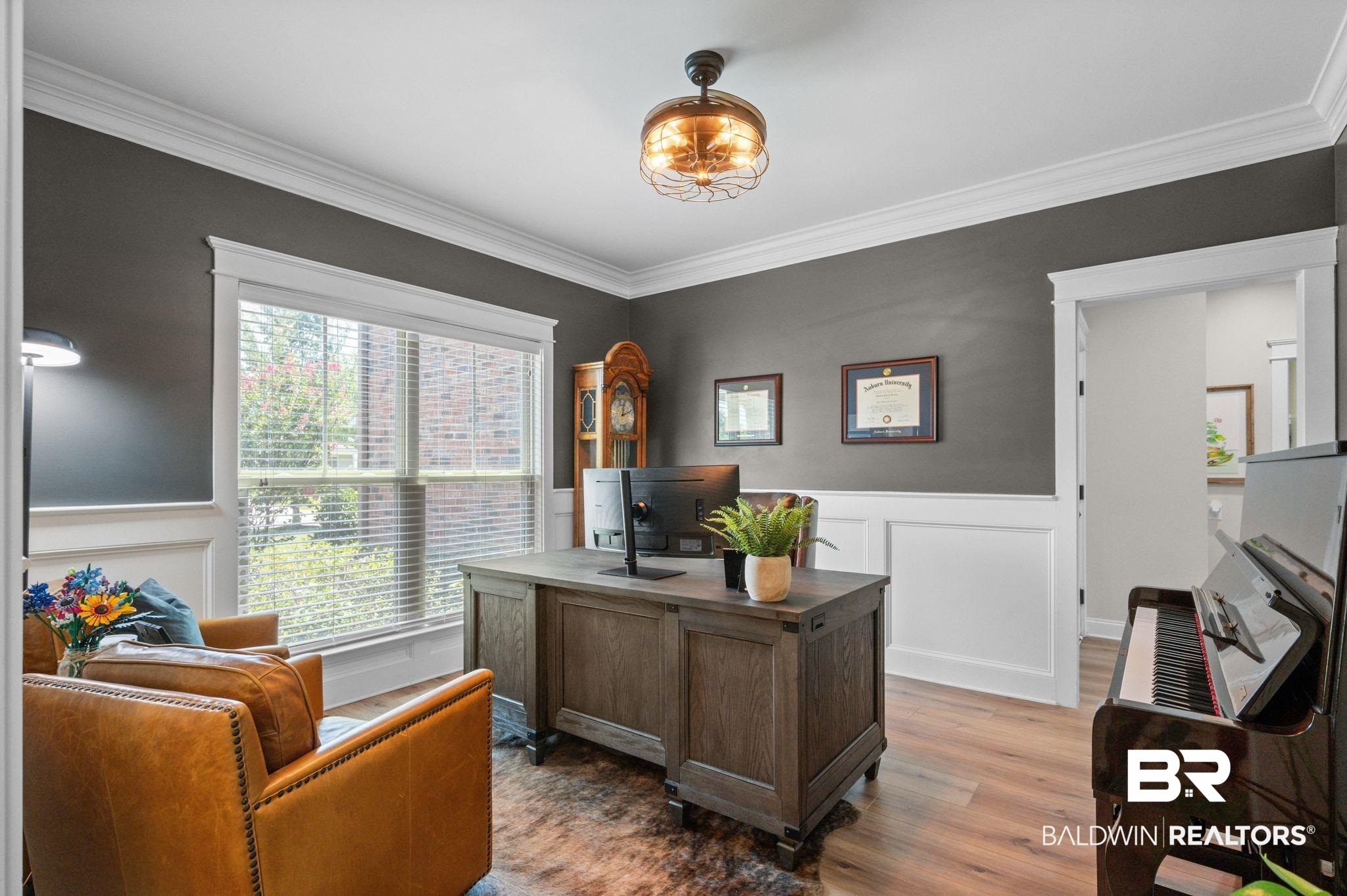 409 Fortune Drive Fairhope, AL 36532 - Photo 22 of 42 Room featuring white wainscoting, dark wall paint, and wood-finish flooring