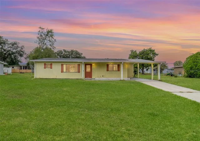 a view of a house with a backyard
