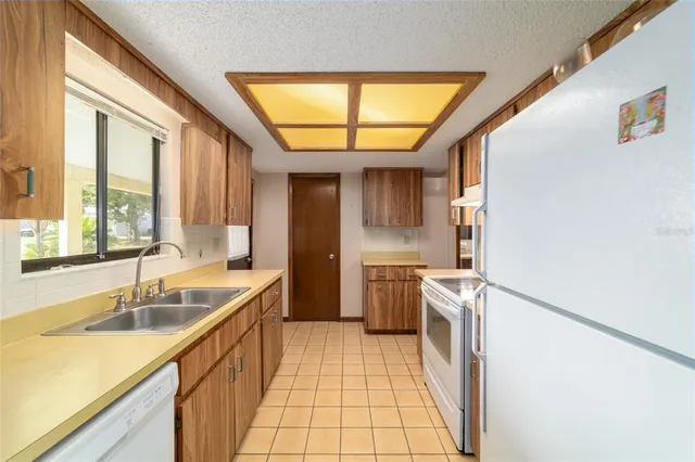 a kitchen with a sink and a refrigerator