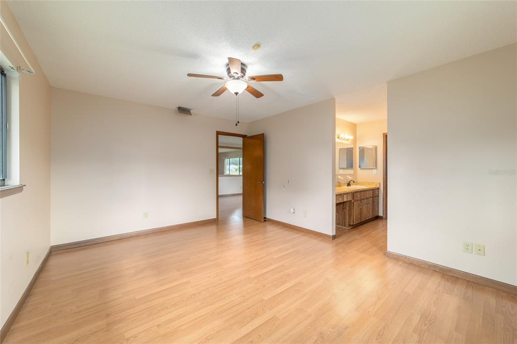8954 Southwest 101st Place Ocala, FL 34481 - Photo 22 of 42 a view of a livingroom with a ceiling fan window and a ceiling fan