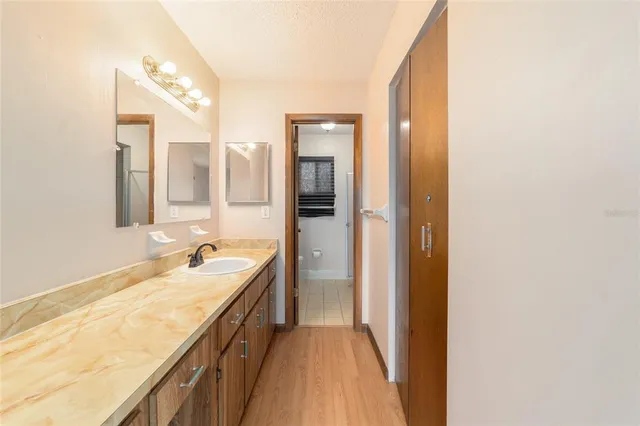 a bathroom with a sink a vanity and a mirror