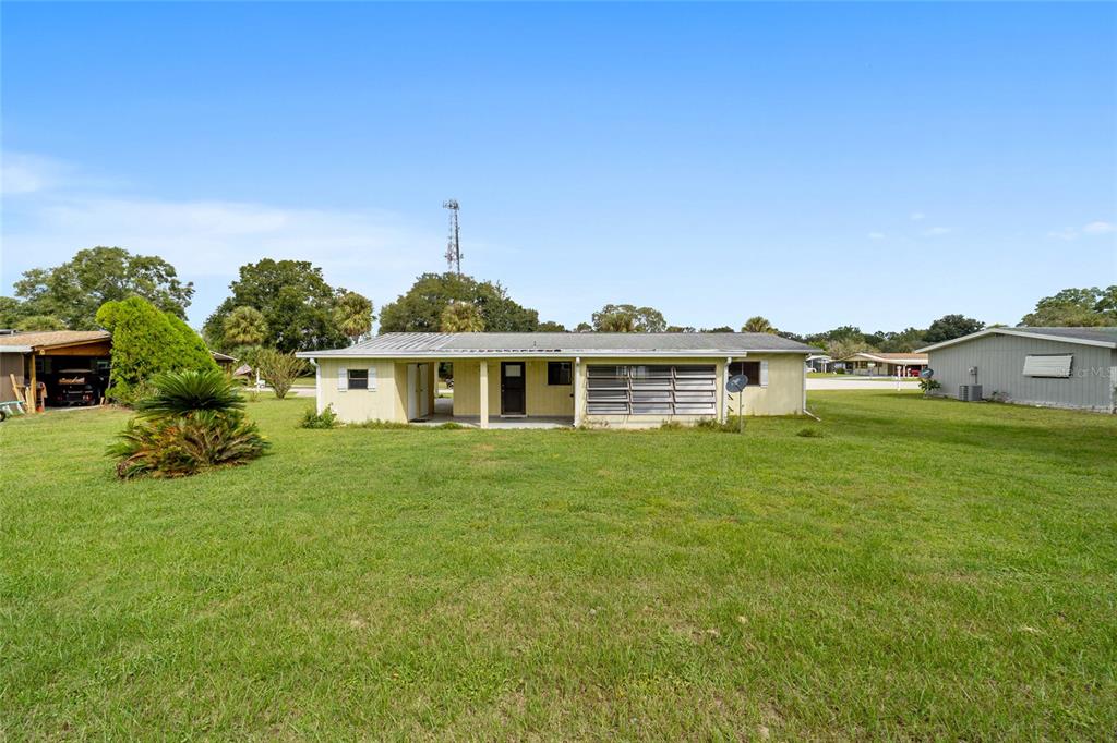8954 Southwest 101st Place Ocala, FL 34481 - Photo 41 of 42 a front view of a house with a garden