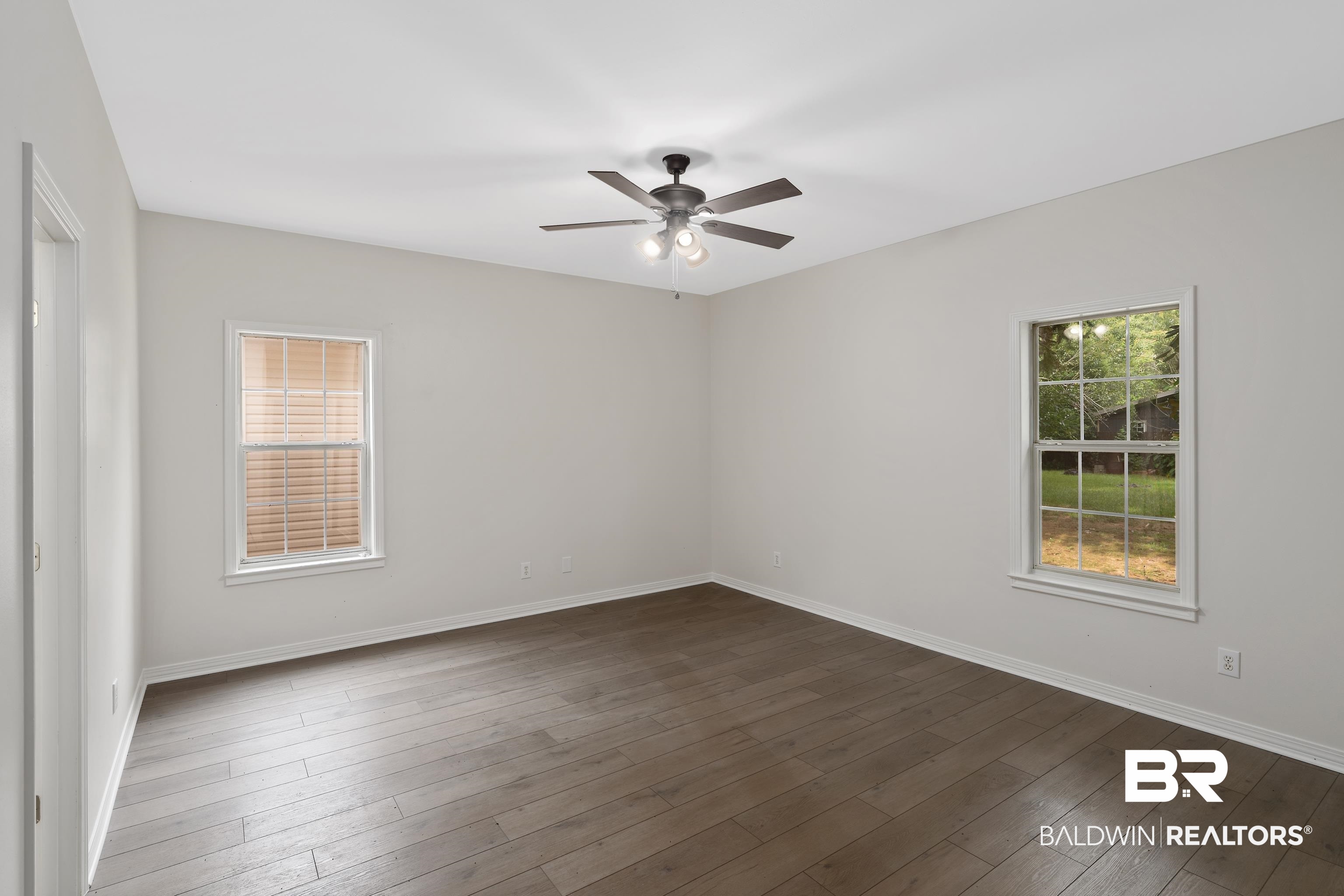 20525 Lawrence Road Fairhope, AL 36532 - Photo 14 of 26 Primary bedroom featuring dark hardwood / wood-style floors and ceiling fan